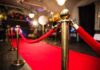 Red carpet with velvet ropes and gold stanchions