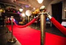 Red carpet with velvet ropes and gold stanchions