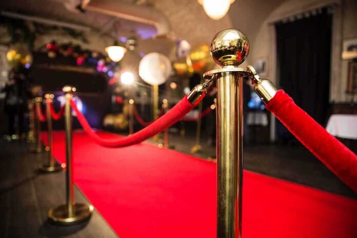 Red carpet with velvet ropes and gold stanchions