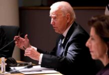 Hunter Torches Garland — ‘Biggest Biden Blunder’ older man in a suit speaking at a meeting table