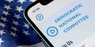 Smartphone showing a political committee webpage on an American flag