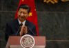 Hormuz Paywall: Beijing Favored, West Squeezed A political leader giving a speech and applauding