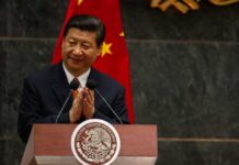 A political leader giving a speech and applauding