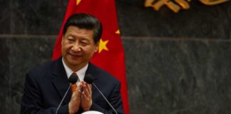 A political leader giving a speech and applauding