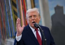 Intel Showdown: Trump Torches 2020 Storyline A man speaking passionately into a microphone with his hand raised