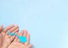 Hands holding a blue sperm shape model