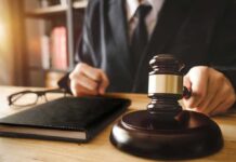 Judge with gavel striking sound block