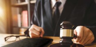 Judge with gavel striking sound block