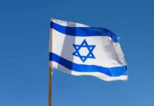 Star of David Becomes Legal Trigger Israeli flag waving against a clear blue sky