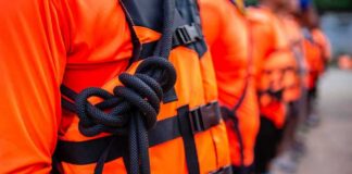 Life jacket with rope knot in a line of people