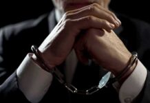 Hamas Cash Pipeline — Charity Boss Nabbed Businessperson in handcuffs with hands clasped