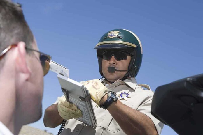 traffic officer writes a citation beside a vehicle