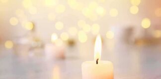 white tealight candle with soft flame