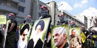 Protesters holding large portrait posters during a street march