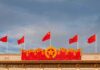 Chinese flags atop a decorated building facade