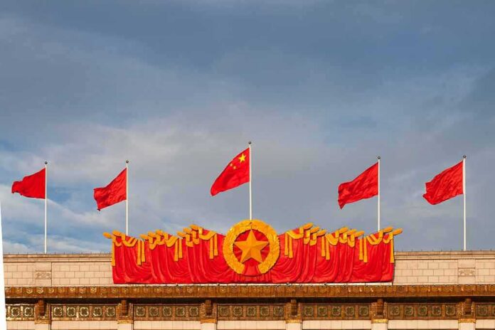 Chinese flags atop a decorated building facade