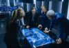 Business team reviewing a glowing digital map table