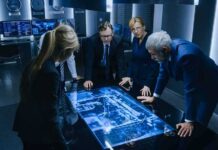 Business team reviewing a glowing digital map table
