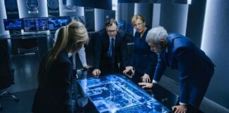 Business team reviewing a glowing digital map table