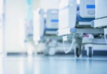 Hospital beds on wheels in a bright corridor