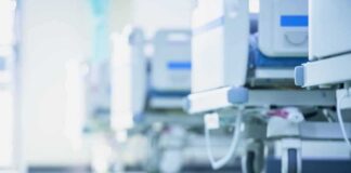 Hospital beds on wheels in a bright corridor