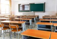 Empty classroom with rows of desks and a chalkboard