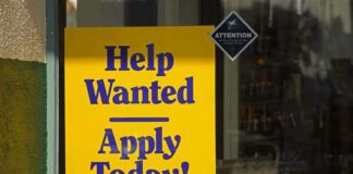 Help Wanted sign in a shop window
