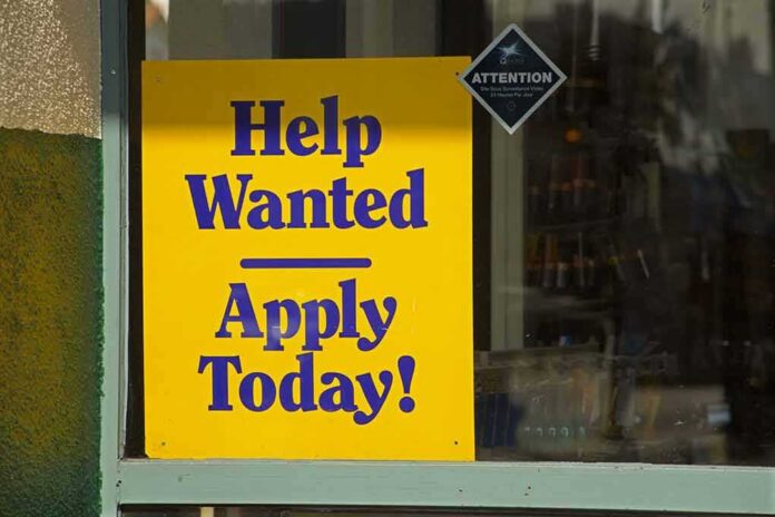 Help Wanted sign in a shop window