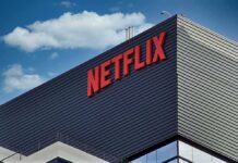 Netflix Cash Clouds $110B Merger Fight Netflix logo on modern office building exterior