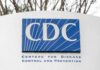 CDC Grant Heist: Extradited Scientist Flips CDC sign on building facade