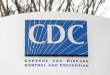 CDC Grant Heist: Extradited Scientist Flips CDC sign on building facade