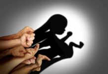 Courtroom Brawl: Who Sets Abortion Rules? Hands forming a shadow of a fetus on a wall