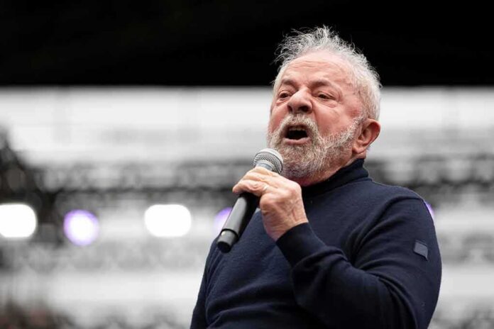 shutterstock_2197241635 Elderly man speaking into a microphone on stage