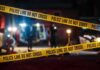 Officer Punched As Fights Explode Police tape cordons off a dimly lit crime scene