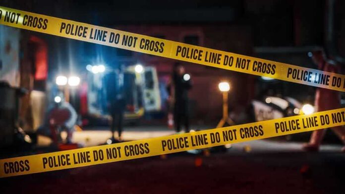 shutterstock_2230645955 Police tape cordons off a dimly lit crime scene