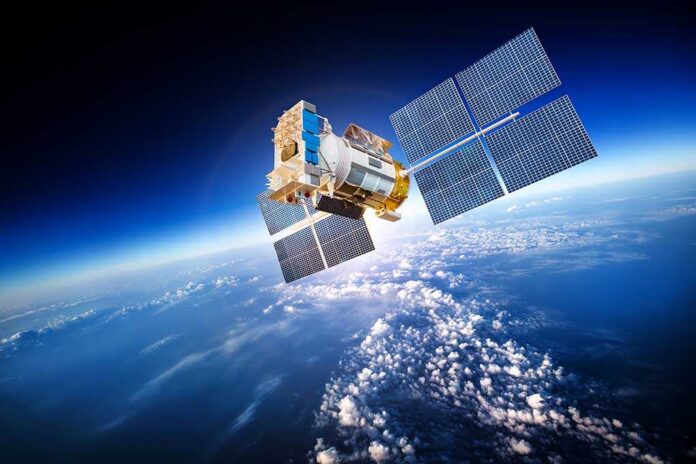 A satellite equipped with solar panels orbiting above the Earth