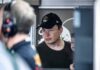 man in black cap looks ahead indoors