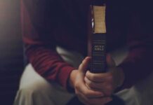 Texas Uproar: ‘Christian Who Hates Christianity’ Person holding a closed Bible while seated