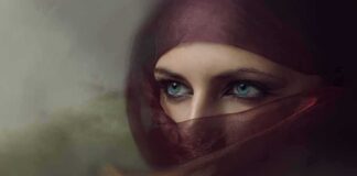 Close-up of eyes framed by a maroon veil