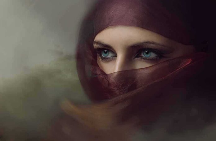 shutterstock_371738041 Close-up of eyes framed by a maroon veil