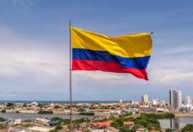 Congress Greenlights Shock Inauguration Swap Colombian flag waving over a coastal city skyline