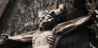 Wooden crucifix of a bearded figure with outstretched arms