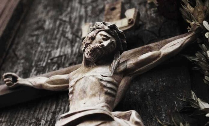 Wooden crucifix of a bearded figure with outstretched arms