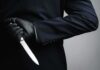 Teacher Down — Students Overpower Attacker Person in dark suit holding a knife behind their back