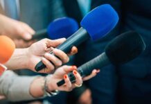 Heat Chaos Exposes NJ Transit Fragility Reporters holding colorful microphones