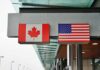 Canadian and American flags displayed at a border crossing