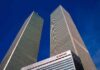 9/11 On Canvas: What Did Bush See? Twin rectangular skyscrapers rising above a hotel facade against a clear blue sky