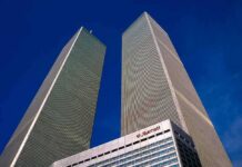 9/11 On Canvas: What Did Bush See? Twin rectangular skyscrapers rising above a hotel facade against a clear blue sky