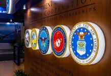 Iran Fight Drained America’s Interceptors Military department seals displayed on a wall