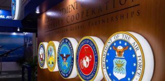 Military department seals displayed on a wall